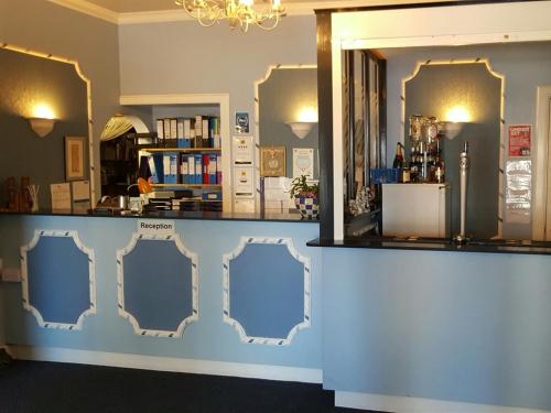 a store with a blue counter with mirrors at Glen Orchy House in Lerwick