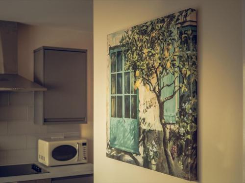 a painting of a window in a kitchen next to a microwave at Hallam Rooms in Boston