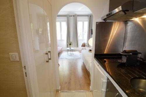 a kitchen with a sink and a counter top at HolidaysInParis - Republique in Paris
