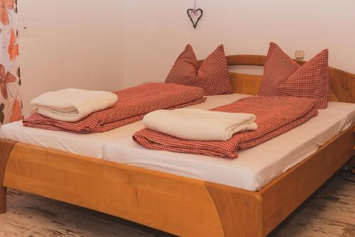 two beds with pillows and towels on top of them at Ferienwohnung Liebel in Altdorf bei Nuernberg