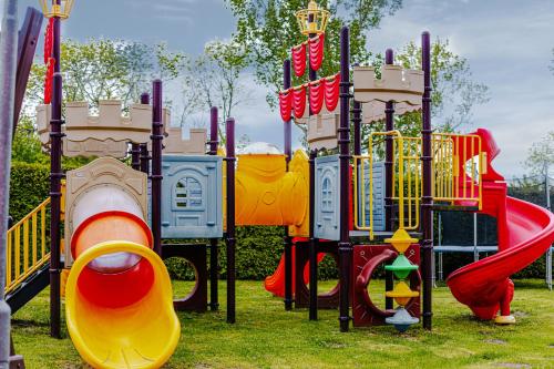 a park with a playground with a slide and a slideintend at Panorama_SPA in Trzęsacz