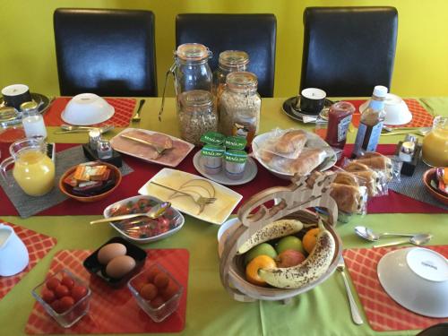 a table topped with plates of food and eggs at Broomlea in Ardersier