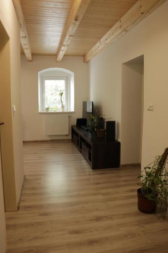 an empty room with a table and a window at Apartmány u Beka in Loučná nad Desnou
