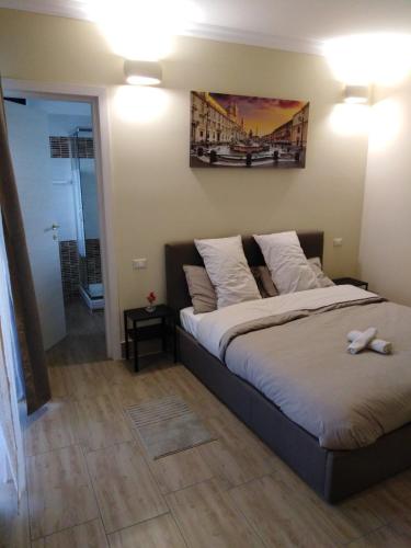 a bedroom with a bed with a bridge picture on the wall at Villa Ivana in Rome