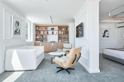 a living room with a couch and a chair at The Marly Boutique Hotel in Cape Town