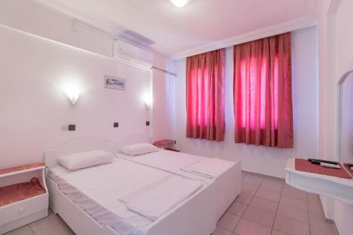 a white room with a bed and a window at Sezin Apart in Marmaris