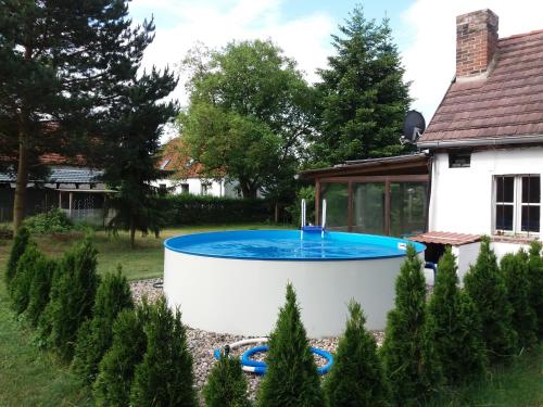 a swimming pool in the yard of a house at Ferienwohnung Runge II in Schönhauser Damm