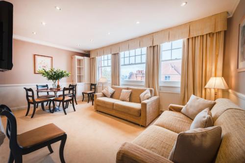 a living room with a couch and a table at No1 The Mansions By Mansley in London