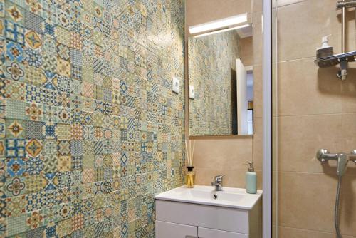 a bathroom with a toilet and a sink and a mirror at Cozy Studio Alvalade in Lisbon