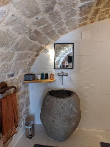 a bathroom with a stone shower with a sink at Domaine des hauts de Vernon in Vernon