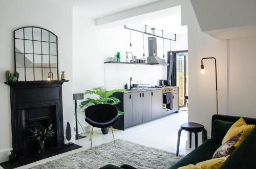 a living room with a couch and a fireplace at Boutique Getaway, edge of Old Town- 4min walk to beach in Margate