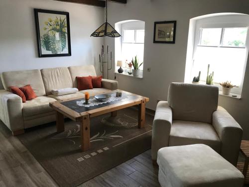 a living room with a couch and a coffee table at Kleine Ferienwohnung bei Kappeln an der Schlei in Kappeln