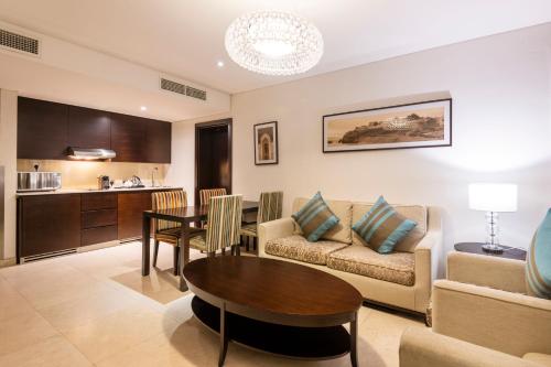 a living room with a couch and a table at Holiday Inn Muscat AlSeeb by IHG in Muscat