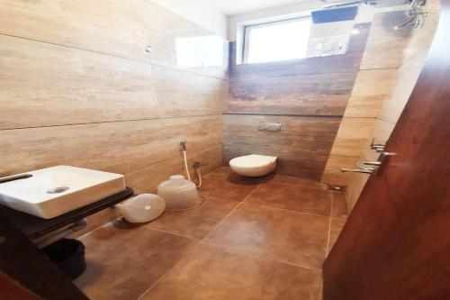 a bathroom with a toilet and a sink at Hotel Satyug in Ujjain