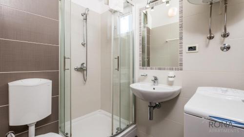 a bathroom with a shower and a sink and a toilet at Rona Apartment Zdravko in Barbariga