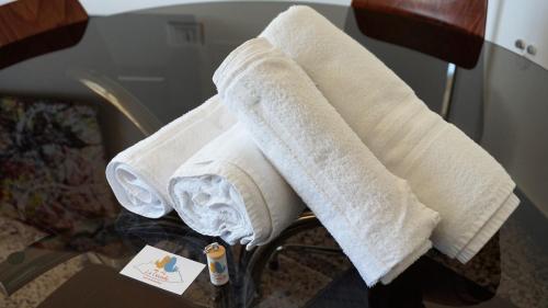 a pile of towels sitting on a chair at Le coccole in Genova