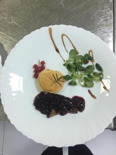 a white plate with fruits and vegetables on it at HOSTEL CPPI Vest in Buşteni