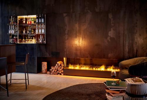a living room filled with furniture next to a fire place at B2 Boutique Hotel Zürich in Zurich