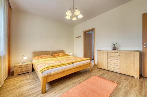a bedroom with a large bed and a dresser and a dresser at Top Appartements Taufner in Waidhofen an der Thaya