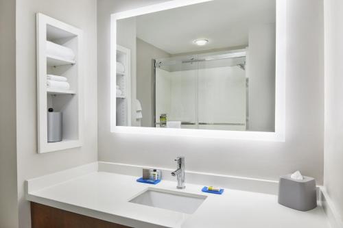 a white bathroom with a sink and a mirror at Holiday Inn Express Palatka Northwest, an IHG Hotel in Palatka