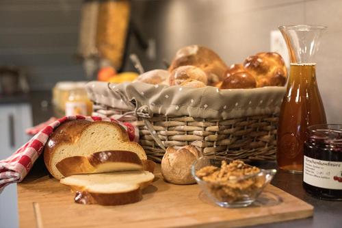 a basket of bread on a table with a basket of bread at Hof-Tschannen in Lengwil