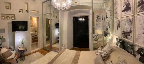 a bedroom with a large bed and a chandelier at Apartment Luxury Palace No1 in Split
