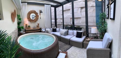 a patio with a jacuzzi tub in a living room at Apartment Luxury Palace No1 in Split