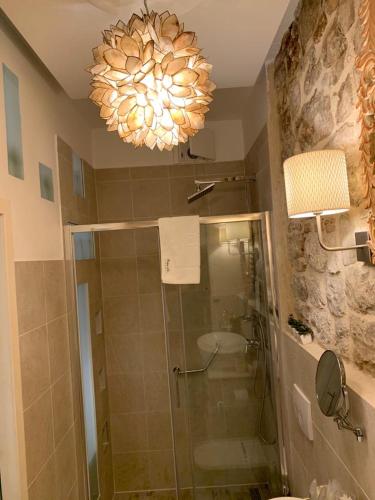 a bathroom with a shower and a chandelier at Apartment Luxury Palace No1 in Split