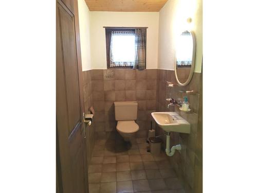 a bathroom with a toilet and a sink at Ferienhaus Somareiva in Savognin