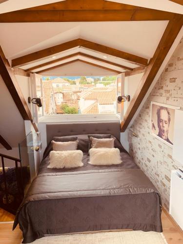 a bed in a room with a large window at Apartment Luxury Palace No1 in Split