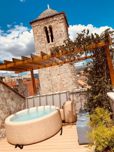 a hot tub sitting on a deck next to a building at Apartment Luxury Palace No1 in Split