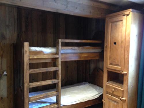 a bunk bed with two bunk beds in a room at chalet clémentine in La Tania