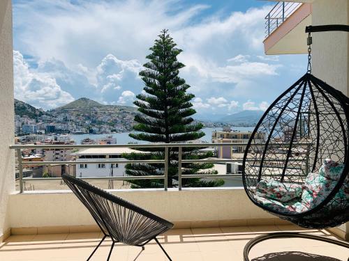 a view of a christmas tree from a balcony with swings at Villa Saral Mar in Sarandë