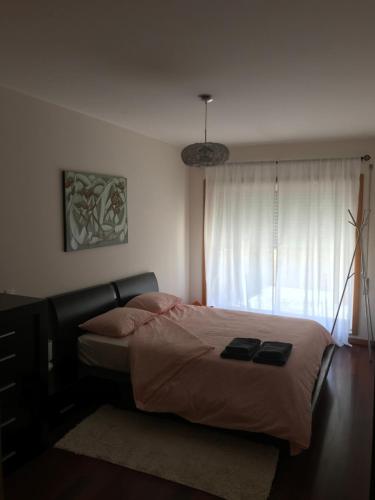 a bedroom with a bed and a large window at Lavra Sea & Sun Beach Apartment (up to 4 guests) in Lavra