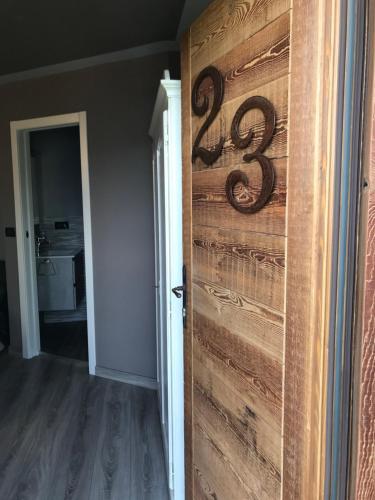 a room with a wooden door with a number on it at Hotel Chacaril in Pila