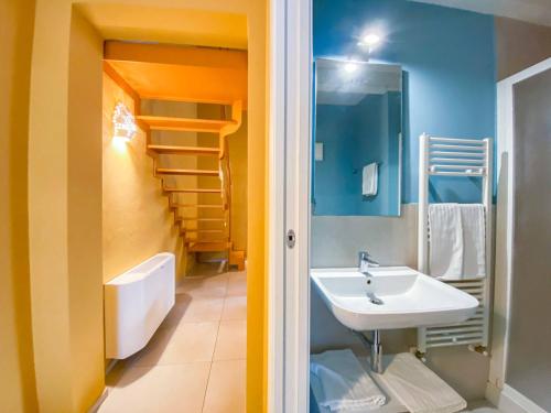 a bathroom with a sink and a toilet and a staircase at Al Giardino Del Nespolo in Polignano a Mare