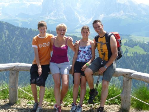 a group of people sitting on a bench on a mountain at Garni Kostner in Ortisei