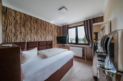 Postel nebo postele na pokoji v ubytování RobrookS Hotel Garni