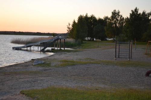 a dock with a playground in the water at Ferienwohnung am Peenetal in Bentzin