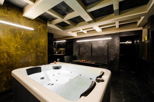a large bath tub in a room with a sink at Apartments in Kaunas city centre with Jacuzzi bath in Kaunas