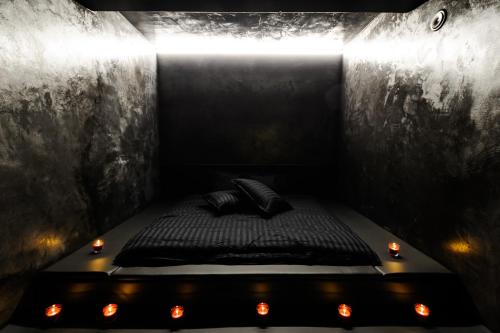 a black bed with lights in a dark room at Apartments in Kaunas city centre with Jacuzzi bath in Kaunas