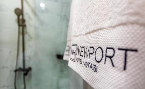 a towel with the wordpter on it in a bathroom at Newport Hotel Kutaisi in Kutaisi