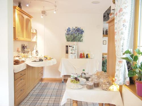 a kitchen with a table with food on it at Apart-Garni Motnaida in Samnaun