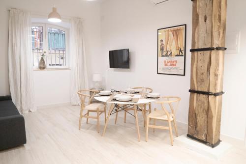 a white dining room with a table and chairs at NUEVO Katu Kale Apartamentuak CENTRO HISTORICO in Getaria