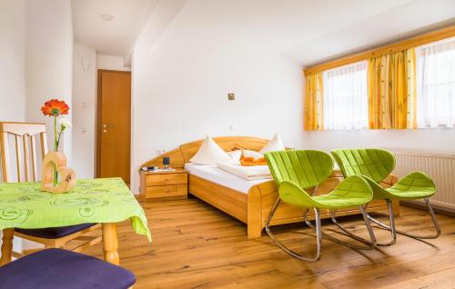 a bedroom with a bed and chairs and a table at Tonibauer in Tamsweg