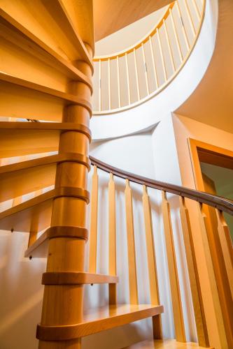 a spiral staircase in a house with wooden railings at Tonibauer in Tamsweg