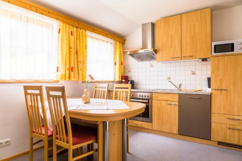 a small kitchen with a wooden table and chairs at Tonibauer in Tamsweg