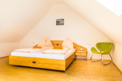a bedroom with a bed and a green chair at Tonibauer in Tamsweg