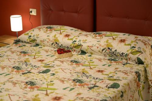 a bed with a bedspread with flowers on it at Agriturismo Villa Adimari in Cerreto Guidi