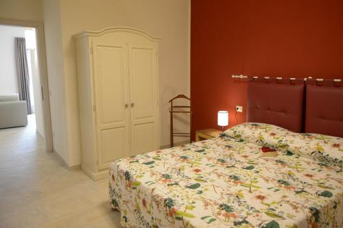 a bedroom with a bed with a floral bedspread at Agriturismo Villa Adimari in Cerreto Guidi
